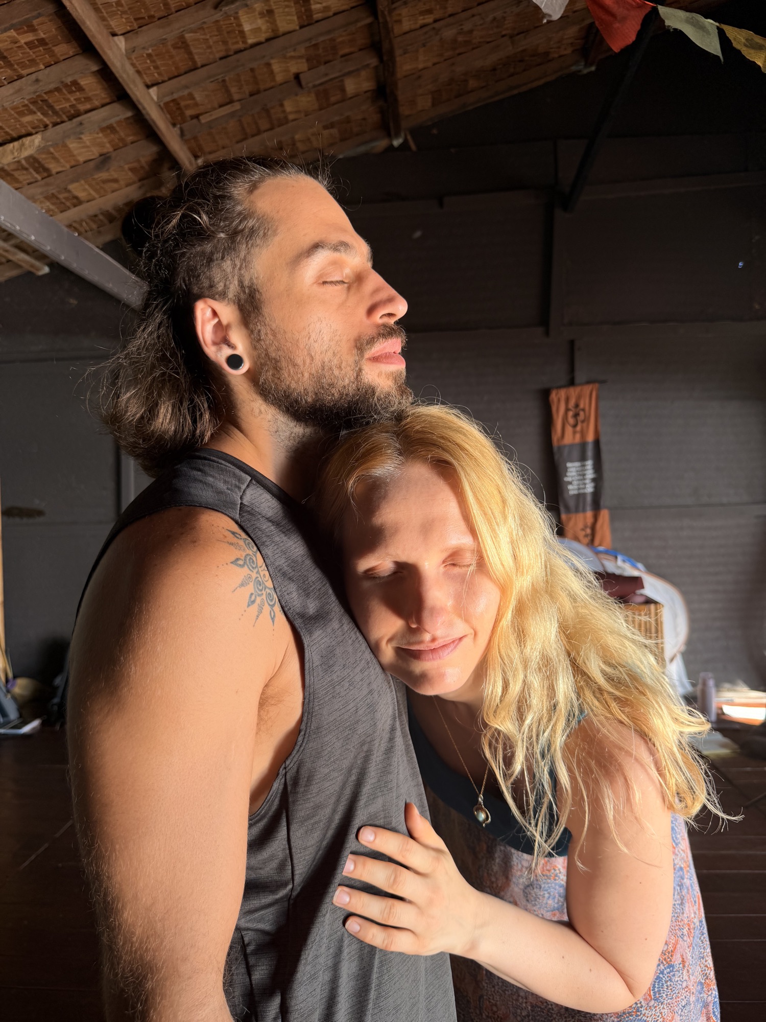 Blonde woman resting into man's chest in tenderness