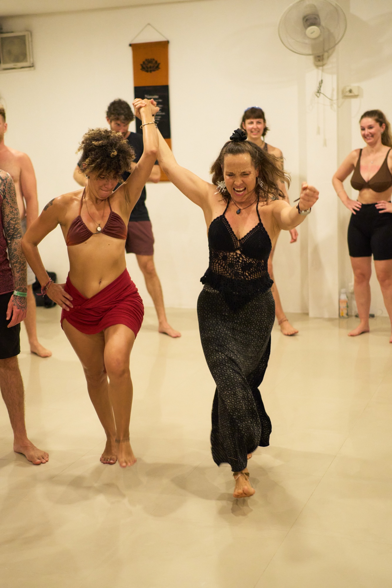 Woman in black and woman in red dancing with vitality